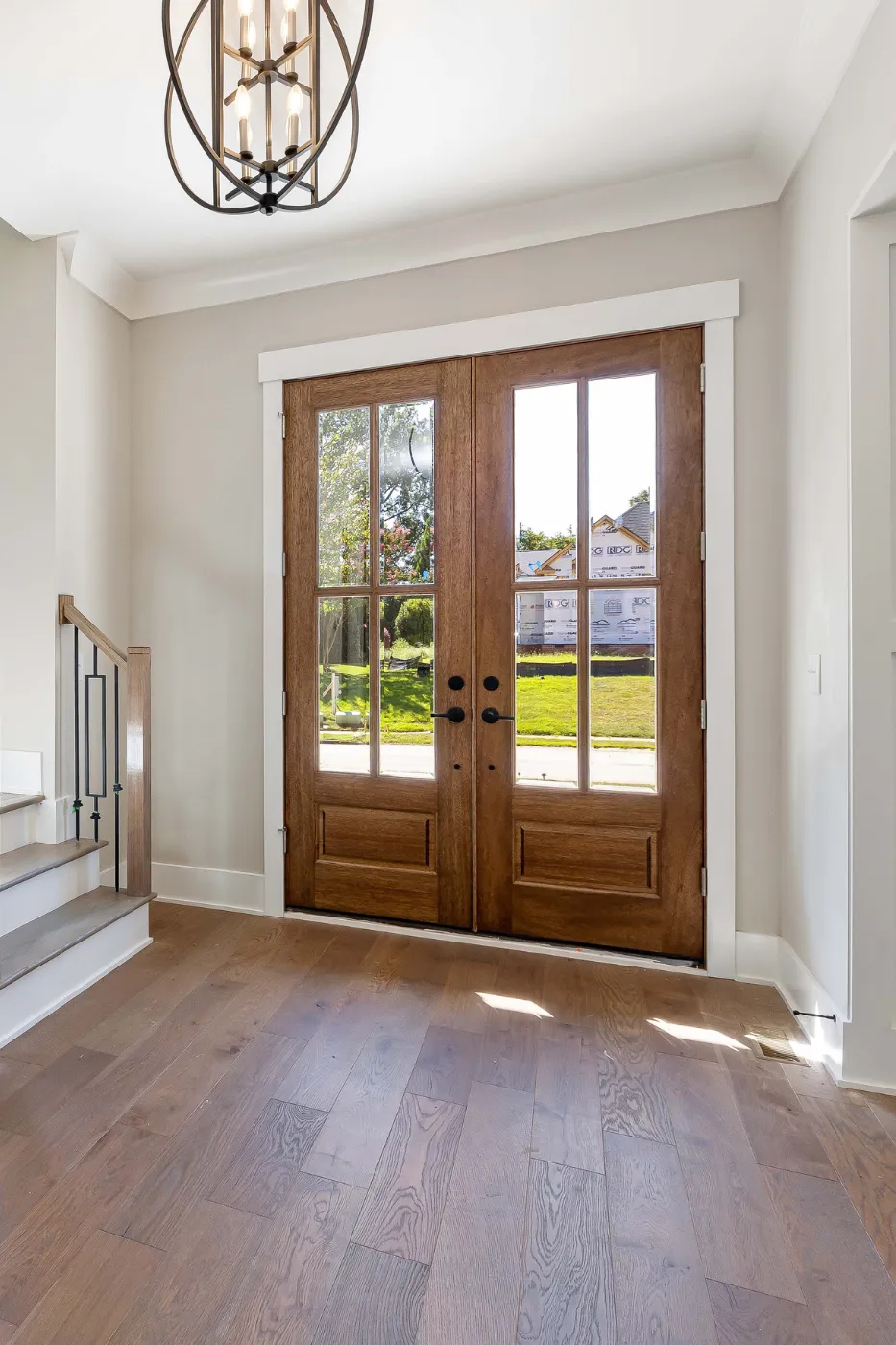 Window and door installer reviewing a residential replacement project during a digital marketing campaign